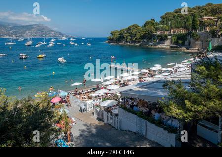 The secluded beach of La Paloma on the French Riviera, surrounded by luxury villas of Saint-Jean-Cap-Ferrat and luxury yachts in the Mediterranean Stock Photo