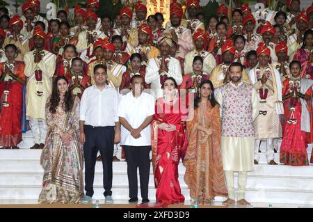 L-R Shloka Mehta (wife of Akash Ambani), Akash Ambani (son of Nita & Mukesh Ambani), Indian business man Mukesh Ambani, Indian philanthropist and business woman Nita Ambani, Isha Ambani (daughter of Nita & Mukesh Ambani) and Anand Piramal (Nita & Mukesh Ambani's son in law) pose for a photo during the mass wedding of 50 underprivileged couples organized by the Ambani family at Reliance Corporate Park in Navi Mumbai. The Ambani family's initiative not only celebrated the union of the couples but also highlighted their commitment to social welfare and community support. In this way, the family i Stock Photo