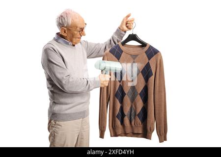Elderly man using a hand steam iron isolated on white background Stock Photo