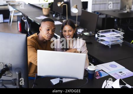 Collaborating at office desk, colleagues discussing project on computer screen Stock Photo