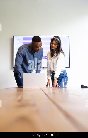 Collaborating on project, colleagues discussing presentation and using laptop in office, copy space Stock Photo