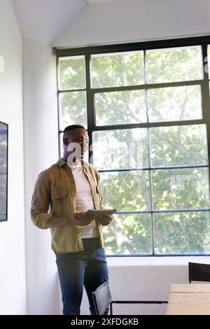 Presenting business proposal, man holding tablet and speaking in office meeting, copy space Stock Photo