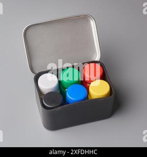 colorful poster color bottles in it's box or container isolated gray background, mock-up template without label, bright paints for artwork craft Stock Photo