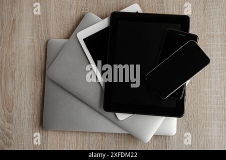 Stack of modern gadgets on wooden table Stock Photo