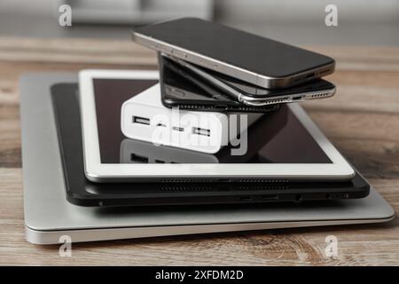 Stack of modern gadgets on wooden table Stock Photo