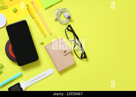 Composition with different modern gadgets and stationery on yellow background Stock Photo