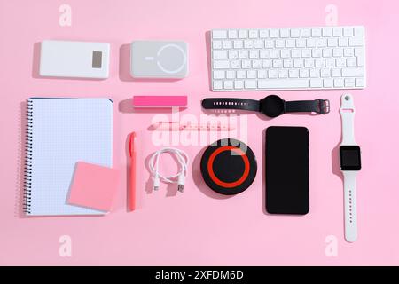 Composition with different modern gadgets and stationery on pink background Stock Photo