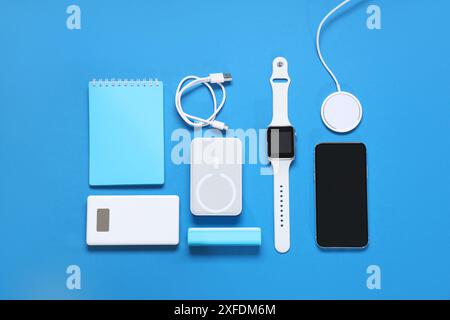 Composition with different modern gadgets and notebook on color background Stock Photo