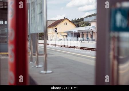 Overview of Grosuplje train station in Slovenia. Looking towards the main building from the second platform, visible boards for station name. Stock Photo