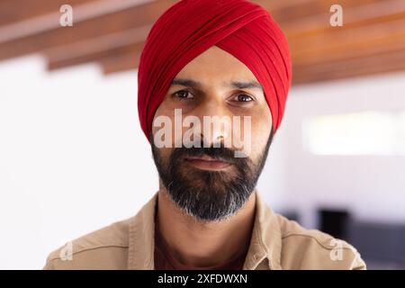 Portrait of Indian man wearing red turban, looking confidently at camera Stock Photo