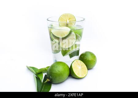 homemade lemonade or mojito cocktail with lime, mint and ice cubes in a glass on a light stone table. Fresh summer drink. With copy space Stock Photo