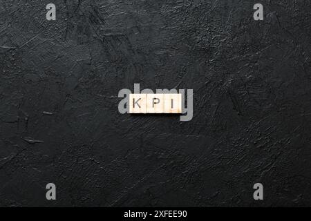 kpi word written on wood block. key performance indicators text on table, concept. Stock Photo