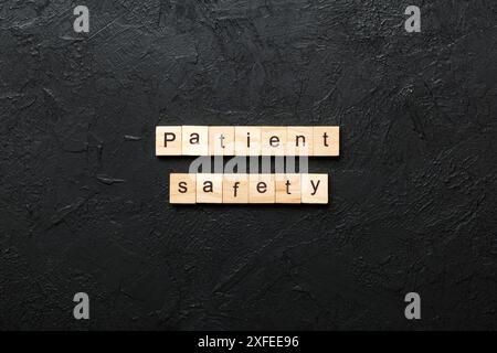 Patient Safety word written on wood block. Patient Safety text on cement table for your desing, concept. Stock Photo