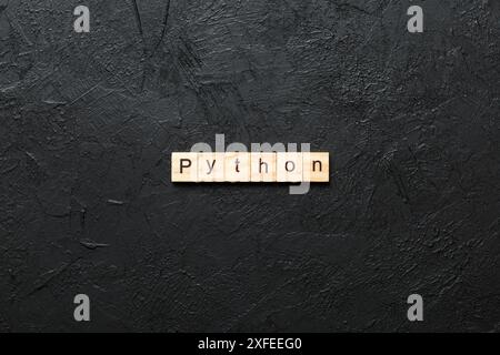 python word written on wood block. python text on table, concept. Stock Photo