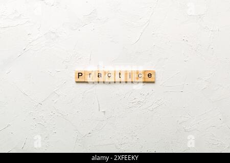 practice word written on wood block. practice text on table, concept. Stock Photo