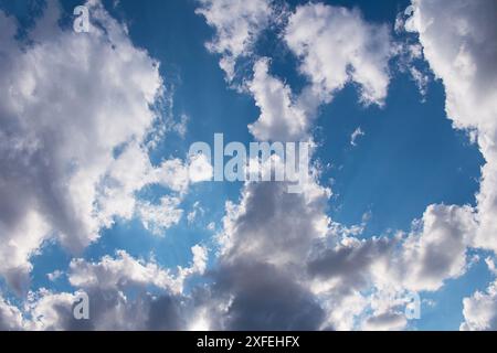 Fluffy cumulus clouds on blue sky. Formation before thunderstorm or after rain. Copy space Stock Photo