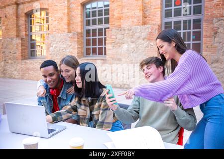 Group of students, prepare for university exams, use a laptop. Stock Photo