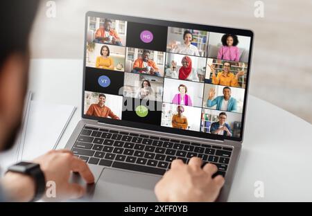 Businessman Using Laptop for Video Conference Meeting With Colleagues Stock Photo