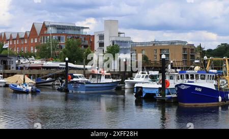 Lymington Harbour, England. 18 June 2024. Landscape showing leisure boats in the marina with waterside buildings in the background. Stock Photo