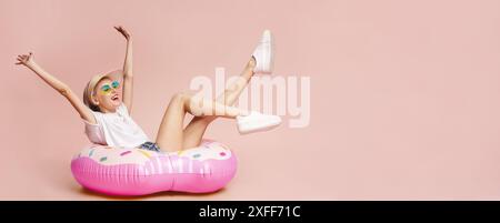 Happy Woman In White Shirt On Pink Donut Float Stock Photo