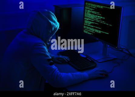 Cybercrime and Hacking Concept. Hacker Using Computer Virus Program Stock Photo
