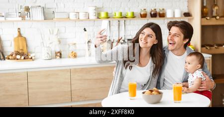 Happy Family Taking a Selfie in a Kitchen During Breakfast Stock Photo