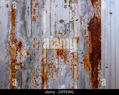 Corroded metal background. The metal walls have rust spots. Rusted metal background with rust marks, rust stains. Rystycorrosion Stock Photo