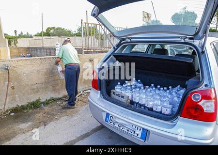 Sicily - San Miceli Aqueduct. Sicily. Province of Trapani. People forced to fill water due to the lack of daily water which leads to water rationing by the aqueducts due to the severe drought in Sicily Editorial Usage Only Stock Photo