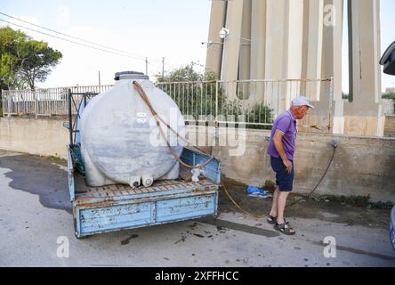 Sicily - San Miceli Aqueduct. Sicily. Province of Trapani. People forced to fill water due to the lack of daily water which leads to water rationing by the aqueducts due to the severe drought in Sicily Editorial Usage Only Stock Photo