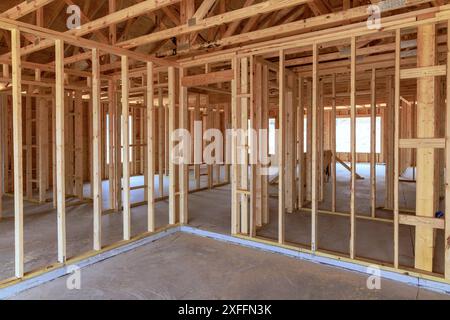 Construction during are assembling wooden beams to form framework of a ...