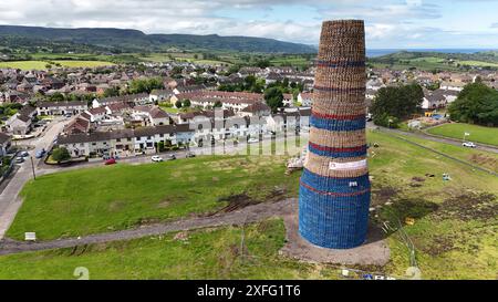 Craigyhill bonfire in Larne, Co. Antrim which is estimated to be 200 feet or 60 meters tall. Picture date: Wednesday July 3, 2024. The burning of loyalist bonfires is part of the traditional Twelfth commemorations marking the anniversary of the Protestant King William's victory over the Catholic King James at the Battle of the Boyne in 1690. Stock Photo