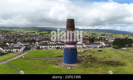 Craigyhill bonfire in Larne, Co. Antrim which is estimated to be 200 feet or 60 meters tall. Picture date: Wednesday July 3, 2024. The burning of loyalist bonfires is part of the traditional Twelfth commemorations marking the anniversary of the Protestant King William's victory over the Catholic King James at the Battle of the Boyne in 1690. Stock Photo