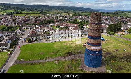 Craigyhill bonfire in Larne, Co. Antrim which is estimated to be 200 feet or 60 meters tall. Picture date: Wednesday July 3, 2024. The burning of loyalist bonfires is part of the traditional Twelfth commemorations marking the anniversary of the Protestant King William's victory over the Catholic King James at the Battle of the Boyne in 1690. Stock Photo