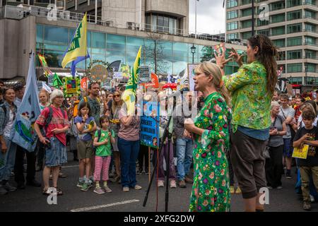 London / UK - Jun 22 2024: An activist speaks with a sign language interpreter the Restore Nature Now march for environmental protections. 350 ogroups Stock Photo