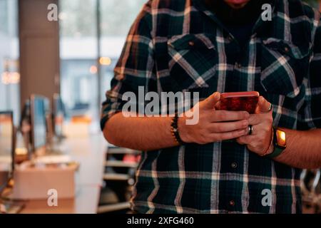 Close Up Young Bearded Programmer Using Smartphone in Office Stock Photo