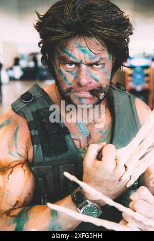 HARROGATE, UK JUNE 22, 2024. Close up portrait of a male cosplayer dressed as an interpretation of Wolverine from the Marvel Universe and looking angr Stock Photo
