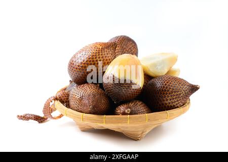 Salak (Salacca zalacca) or Snake fruits on bamboo basket isolated on white background Stock Photo