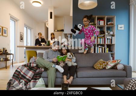 Happy family spending leisure time with each other in living room at home Stock Photo