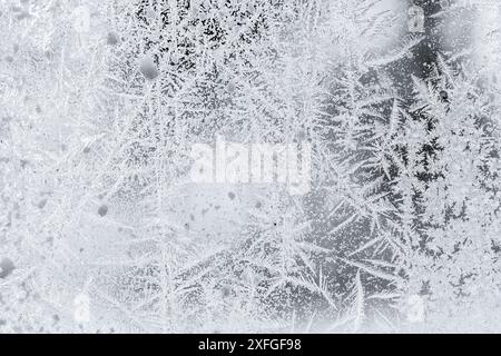 Pattern of white frost on a window glass, macro photo, natural winter background Stock Photo