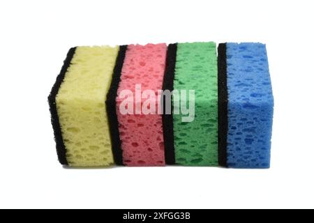 Several multi-colored dishwashing sponges lie on a white background. Stock Photo