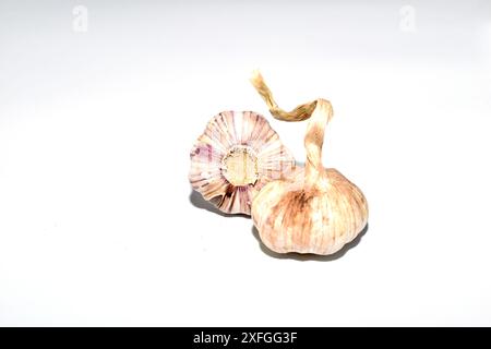 Two heads of hot garlic lie on a white background. Stock Photo