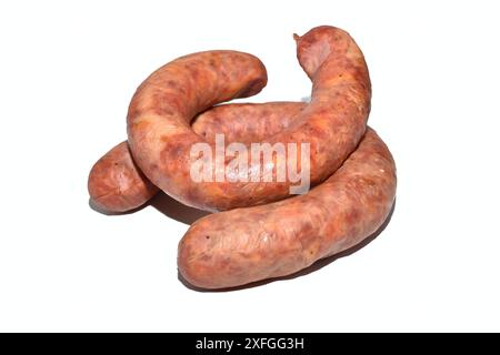 On a white background lies a sausage made from pork meat with the addition of garlic. Stock Photo