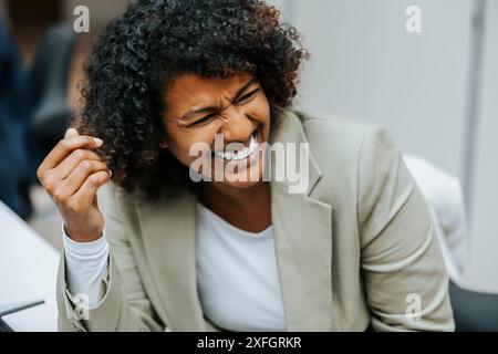 High angle view of happy female business professional with curly hair at office Stock Photo