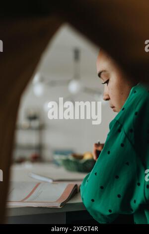 Focused girl doing homework at home Stock Photo