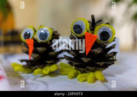 Two decorative owls made of cones. Handmade Stock Photo