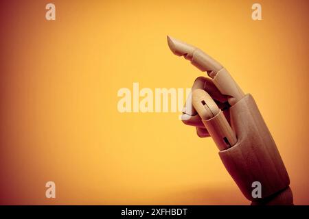 Side view of wooden hand pointing on invisible object Stock Photo