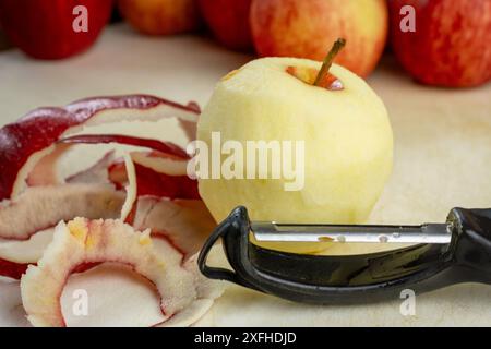 Preparing apple for a pie.  Peeling gala apples. Stock Photo