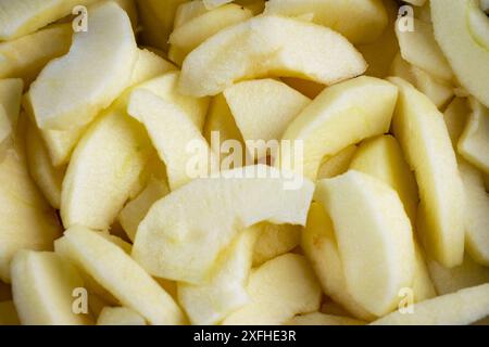Close up view of gala apple slices in salt water.  Preparation for a pie. Stock Photo