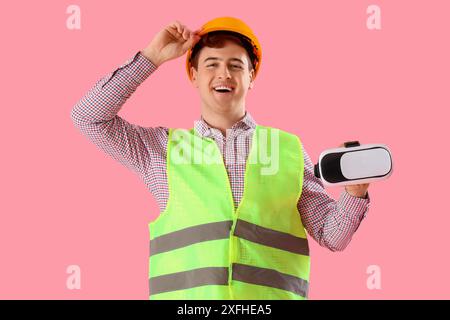 Male worker with VR glasses on pink background Stock Photo