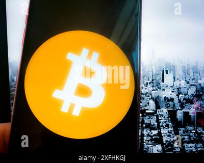 New York, New York, USA. 1st July, 2024. Bitcoin, introduced in 2009 by an anonymous entity known as Satoshi Nakamoto, is the first and most well-known cryptocurrency. It operates on a decentralized ledger called blockchain, which ensures transparent and secure transactions. Bitcoin is often referred to as digital gold due to its finite supply of 21 million coins. It has become a popular investment and a hedge against traditional financial systems, influencing the development of countless other cryptocurrencies. (Credit Image: © Taidgh Barron/ZUMA Press Wire) EDITORIAL USAGE Stock Photo